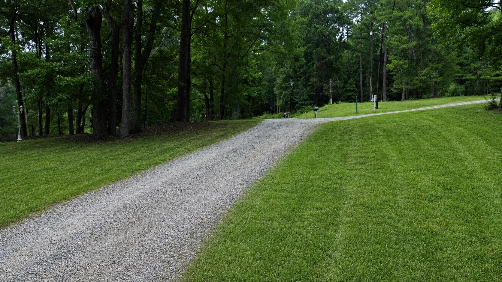 Maintained gravel drive through the wooded RV sites